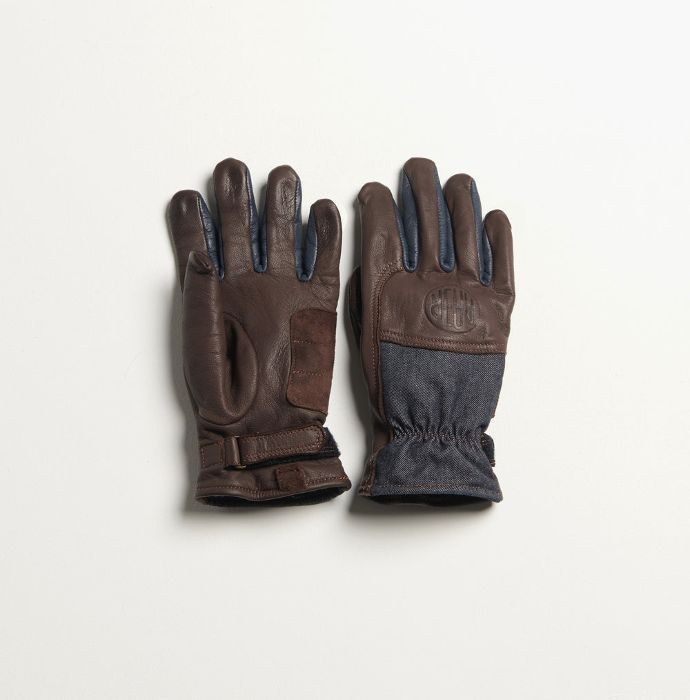 Gants ALAMO posés côte à côte, montrant le cuir marron, le dessus en denim et la paume.