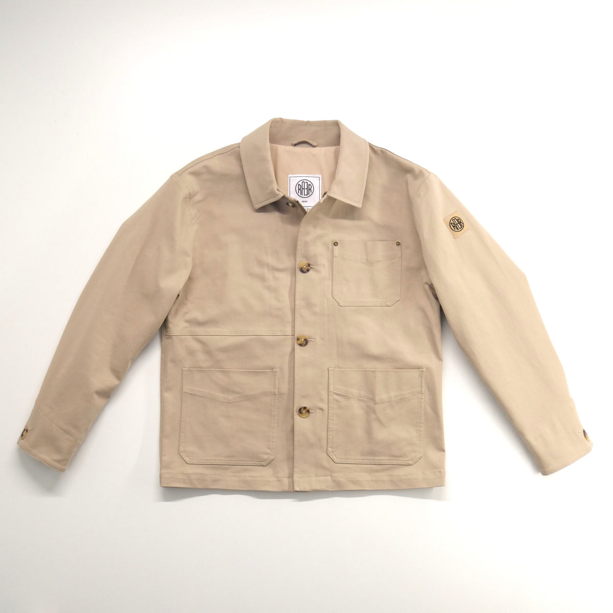 Veste ARTIST beige à plat, vue de face avec les boutons et les poches visibles.