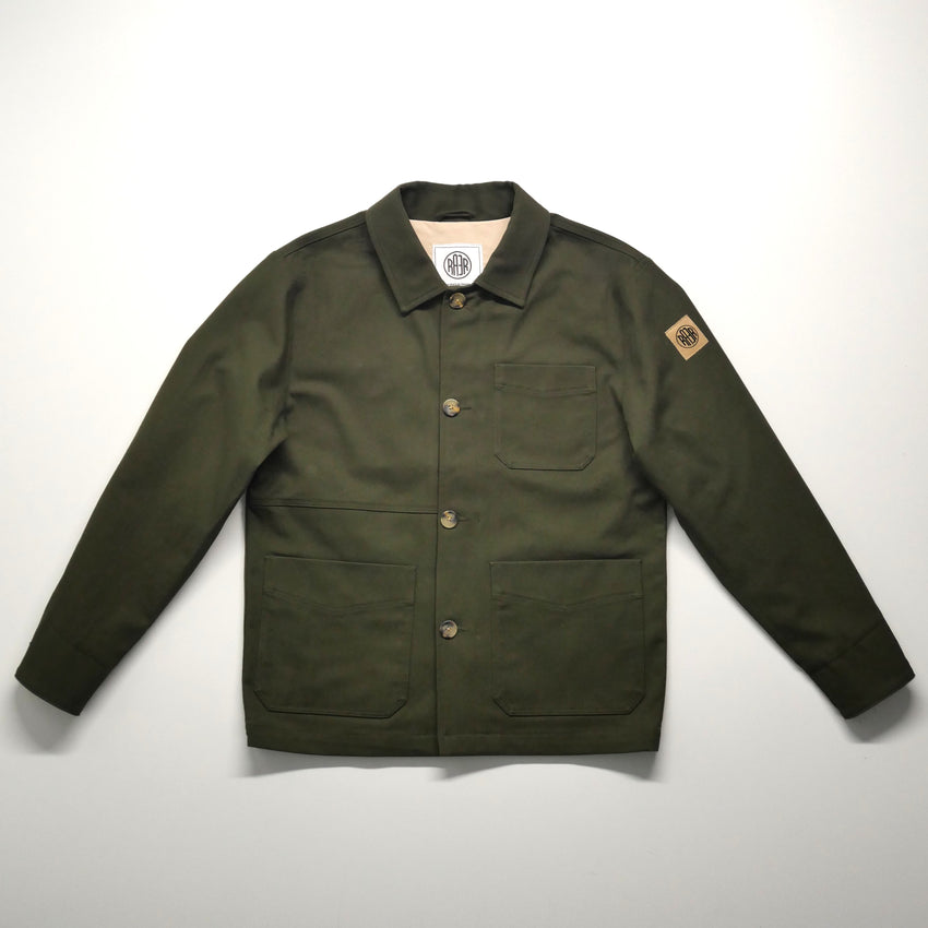 Veste ARTIST kaki posée à plat, vue de face avec ses poches et sa fermeture boutonnée.